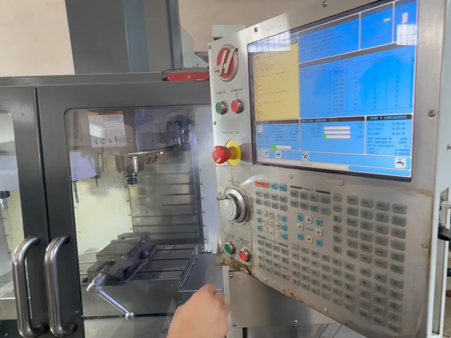 The operator at a Haas pendant loading a program