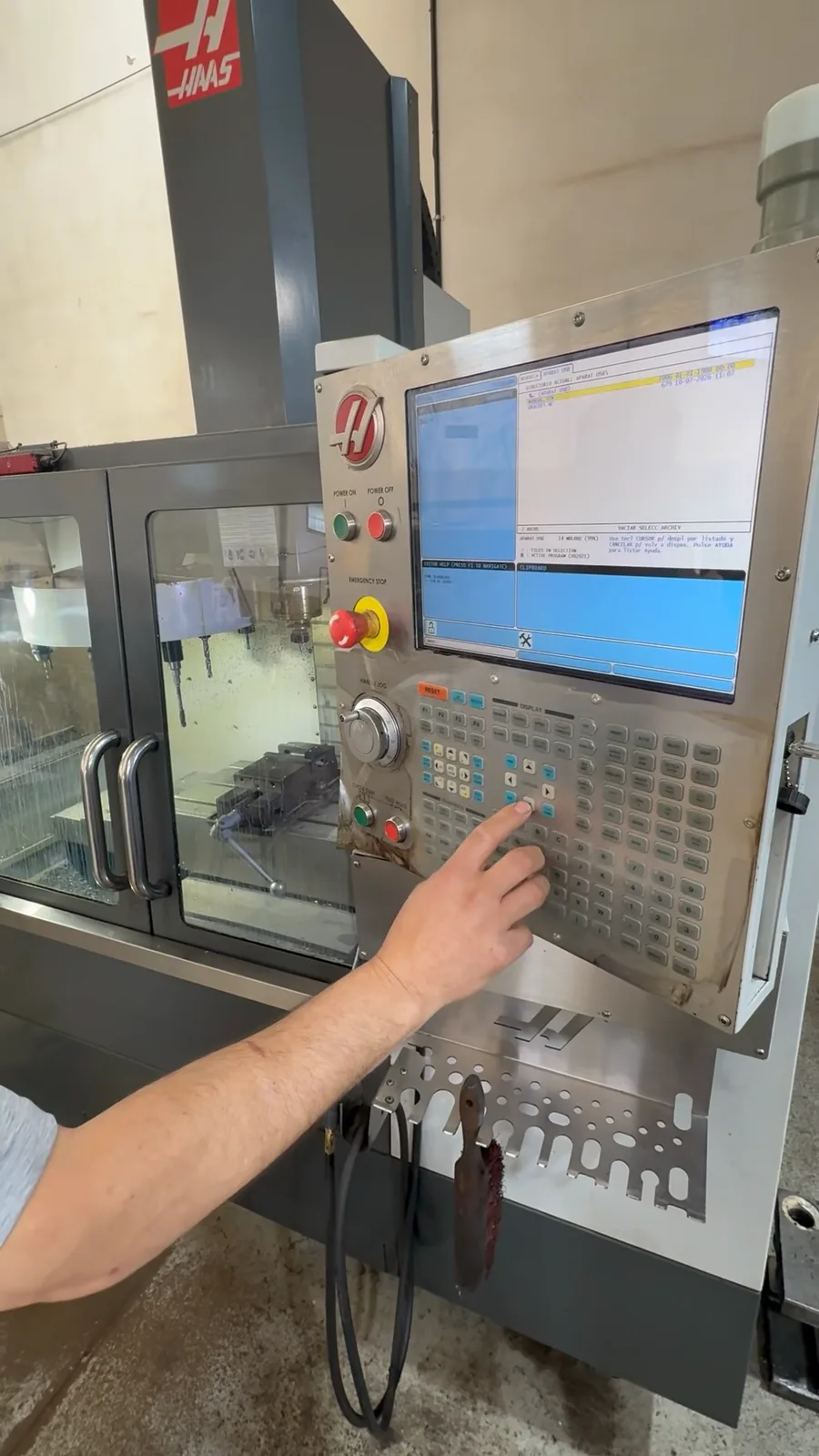 An operator at a Haas pendant, the Haas’s mark above
