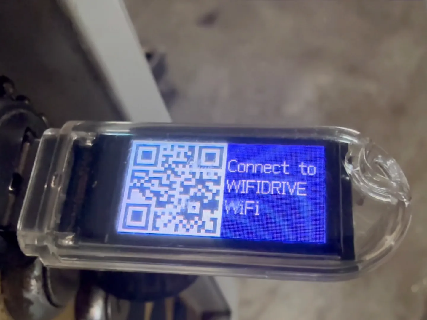 A WiFiDrive in a Haas pendant’s port, showing the code that joins its network