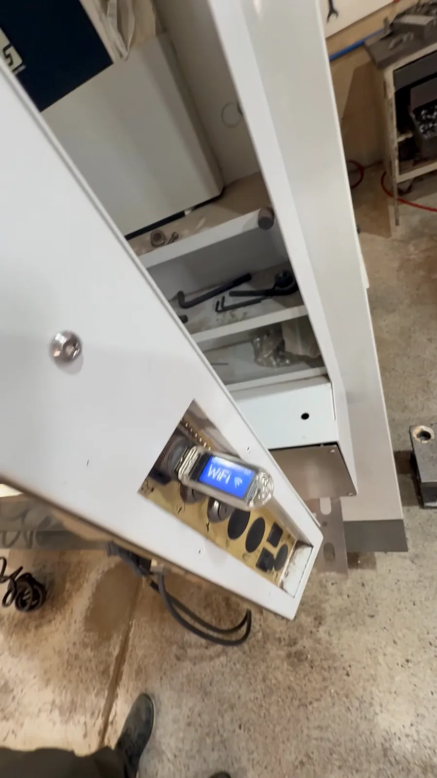 A hand at the WiFiDrive in a Haas pendant’s side port