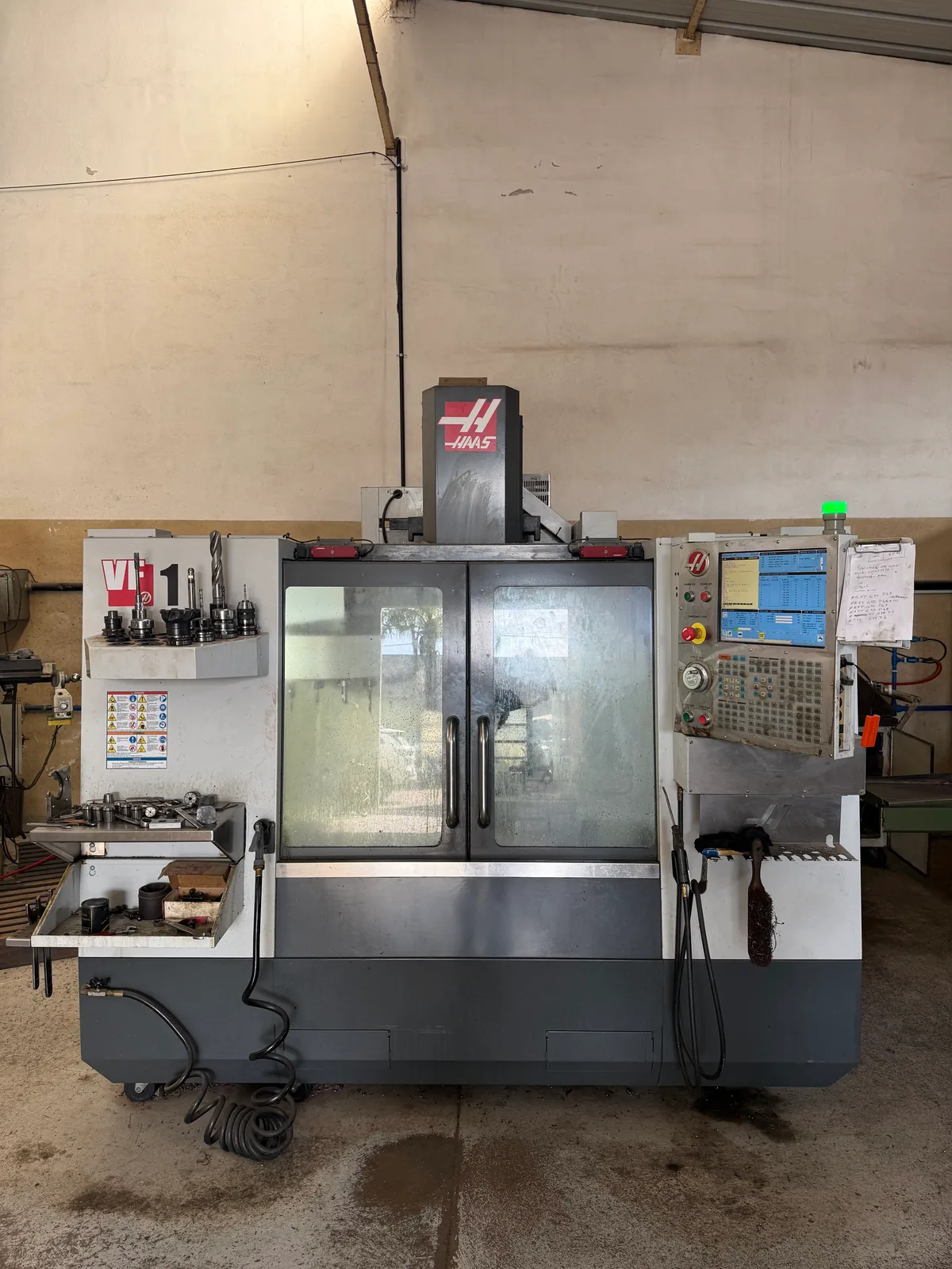 A Haas VF-1 in a shop, its pendant on