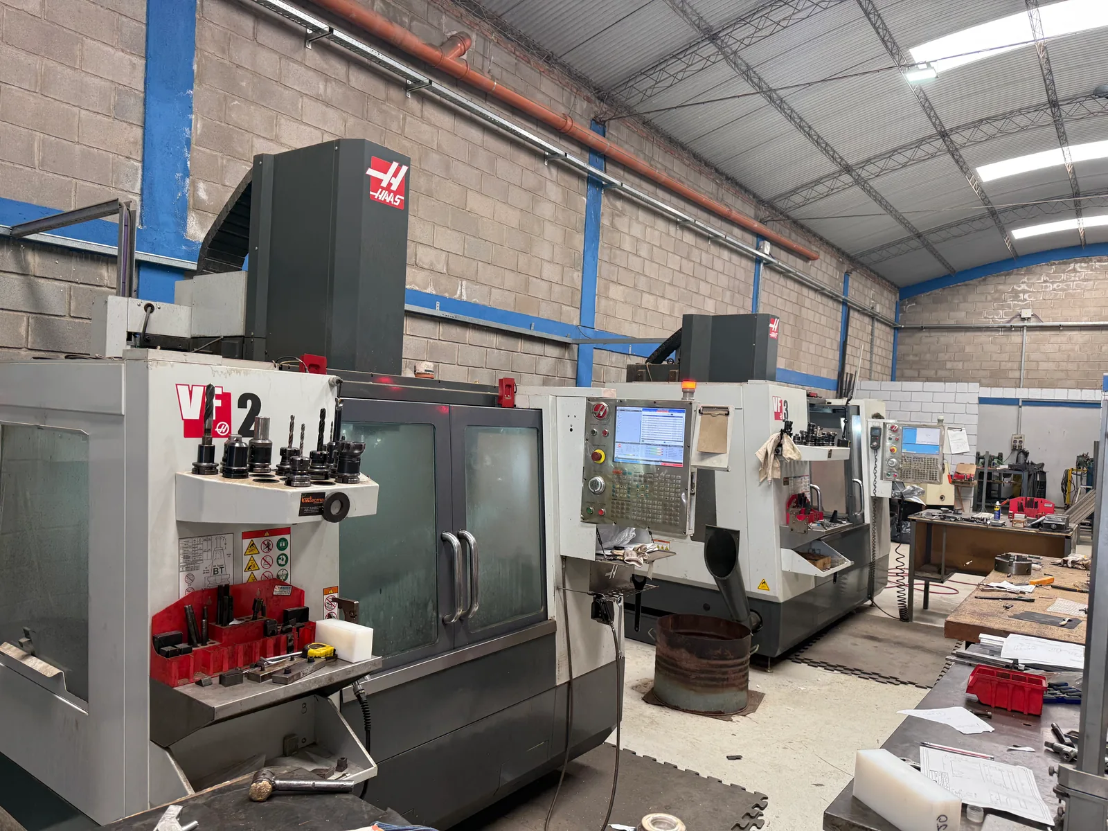 A Haas VF-2 and, behind it, a VF-3, in a shop