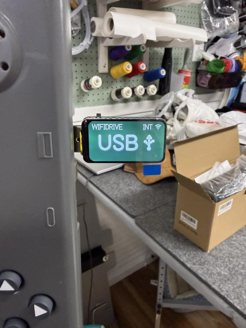 The WiFiDrive in USB mode in the side of a Bernina E 16 PRO's touchscreen console