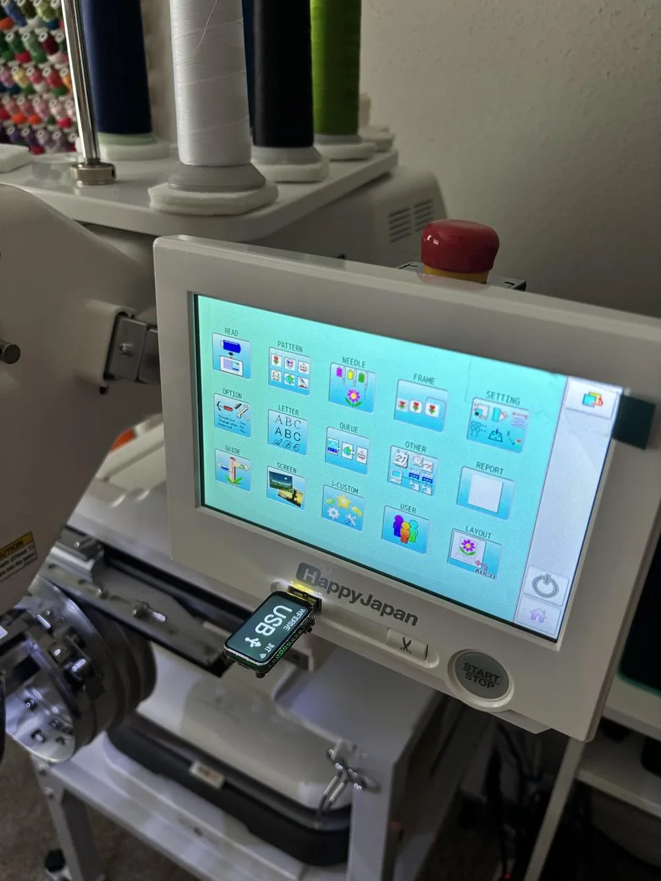A HappyJapan HCH-701P with the WiFiDrive in USB mode in the USB port below its touchscreen, which shows the main menu